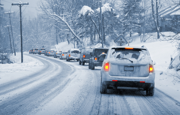 Snow covered Connecticut roadway with winter driving conditions